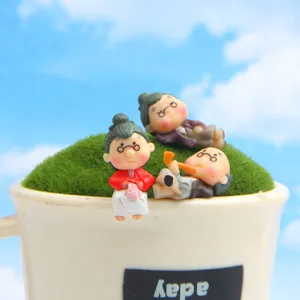 Close-up detail of cute elderly couple resin figurines, perfect for succulent DIY garden decor.