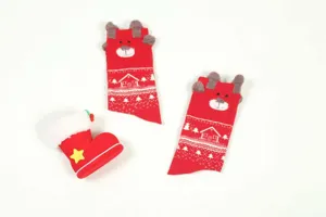 Detailed shot of red Christmas socks with cute 3D plush bear ears and festive snowflake patterns.