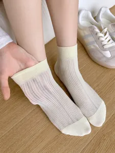 Detail shot of women's ribbed mesh short socks, stretchy ankle cuff, breathable summer wear.