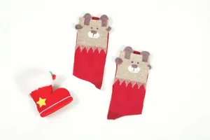 Close-up view of cute cartoon bear Christmas socks in red with 3D ears and festive details.