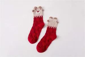 Detailed view of red Christmas mid-calf socks featuring cute 3D bear ears and snowflake pattern.