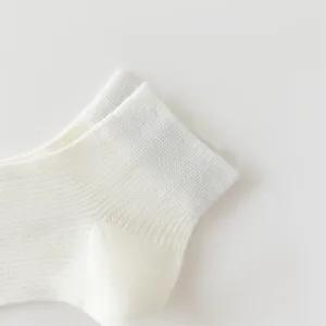 Close-up detail of white women breathable mesh ankle socks, soft cotton fabric texture.