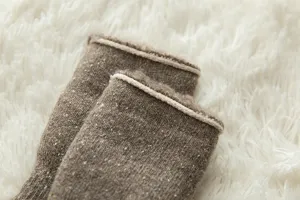 Thick winter wool socks detail close-up, cozy brown knit thermal snow socks for women.