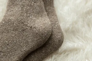 Close-up detail of thick thermal winter wool socks texture showing soft cozy fabric and knit.