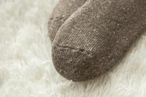 Close-up detail of thick thermal fleece wool socks showing soft knitted texture for winter warmth.