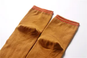 Close-up detail of brown mid-tube cotton socks with double red stripes at the top rib.