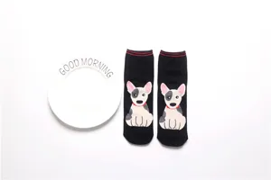 Detailed view of women's black mid-calf socks featuring a cute cartoon dog pattern design.