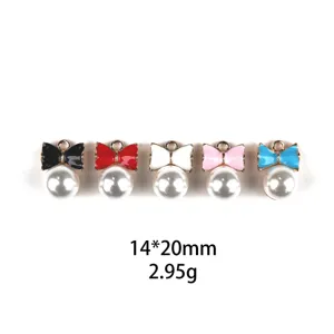 Detail shot of colorful bow and pearl alloy charms, perfect for DIY jewelry and keychains.