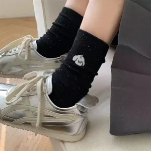 Cute dog embroidered mid-tube socks for women, fashionable black speckled cotton daily wear.