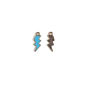 Detail view of two metal lightning bolt enamel charms in blue and black finish for DIY jewelry.