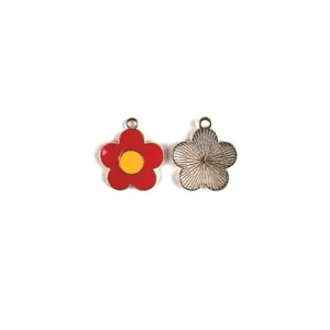 Detail shot of five-petal red enamel flower charm with yellow center, metallic back.
