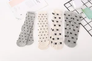 Detail shot of summer thin mesh women socks featuring cute bow and polka dot patterns.