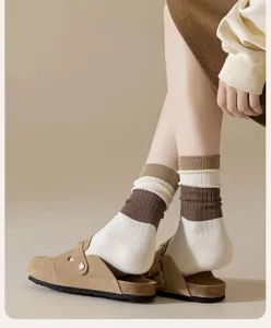 Brown striped mid-calf knit socks detail, cozy Maillard style autumn winter footwear.