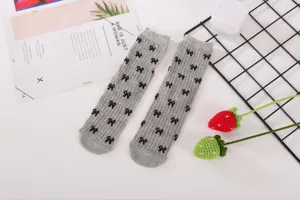 Grey bow mesh socks detail showing the delicate bow pattern and breathable knit texture.
