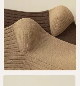Close-up detail of women's ribbed knit socks featuring brown and beige autumn tones.