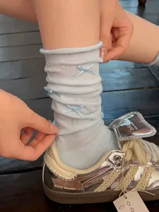 Cute light blue sheer stacked socks with small bows for women, sweet and breathable design.