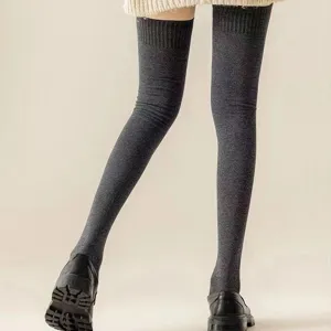 Detail view of dark gray over the knee knit socks, thick warm winter long stockings.