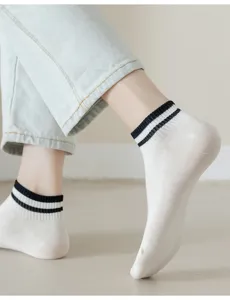 Close-up detail of women breathable low-cut short white socks with black double stripes design.