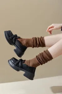 Women solid color casual knit slouch socks paired with black chunky platform loafers style.