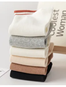 Detailed shot of stacked women's cotton socks in assorted neutral colors and stripes.