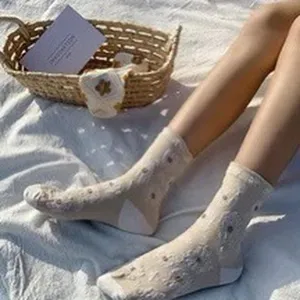 Beige mid-tube socks featuring cute floral details, soft fabric, perfect for daily wear.