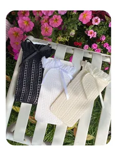 Detailed shot of women white black beige lace mid calf socks featuring cute bow knots.