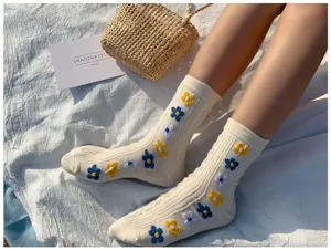 Detail shot of Korean style floral knit mid-tube socks in beige with cute embroidered flowers.