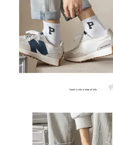 White couple sports mid-tube socks with letter P embroidery, breathable and comfortable cotton.