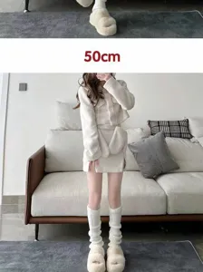 Detailed view of knitted leg warmers and cozy fluffy slippers in a soft indoor home setting.