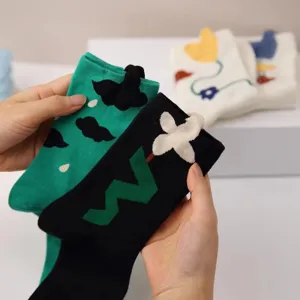 Detail view of cute creative 3D design women mid tube socks with trendy aesthetic style.