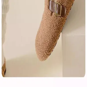 Brown fleece clog shoe detail, cozy winter sherpa slip on footwear with leather strap.
