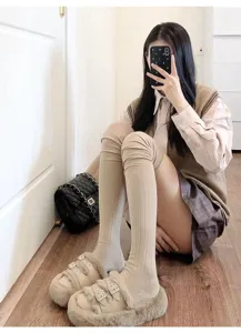 Detailed shot of cozy ribbed over-the-knee socks in solid beige, perfect for autumn winter.
