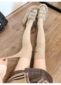 Knit over-the-knee long socks in solid beige with vertical stripes, elastic and cozy detail.