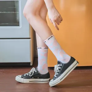 Detailed shot of cute pink cow print mid-calf socks with letter print on ribbed cuffs.