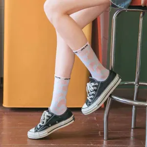 Japanese style cute mid-calf socks paired with classic black canvas shoes for women daily wear.