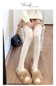 Close-up detail of soft ribbed over-the-knee long socks in solid white for cozy daily style.