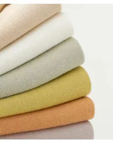 Close-up detail of folded ribbed knit socks in multiple soft colors, soft breathable texture.