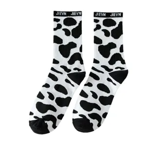 Black and white cow print mid-tube socks for women, cute Harajuku style casual daily wear.