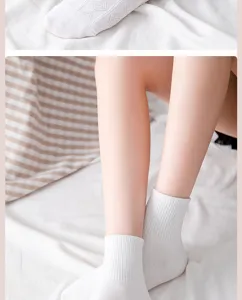 Detail shot of white JK style mid-calf socks with breathable lace and soft fabric.