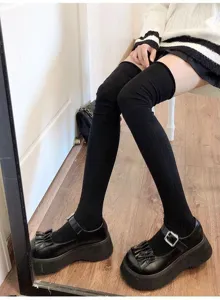 Black over-the-knee ribbed socks detail shot, soft knit fabric for autumn and winter daily wear.