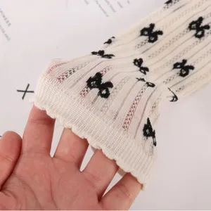 Japanese ballet style mesh mid-tube socks for women, off-white knit with cute black bows.