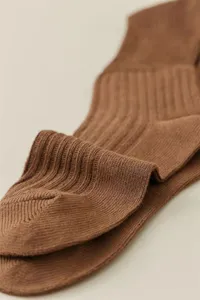 Close-up of brown ribbed knit socks showing soft texture and vertical stripe design.