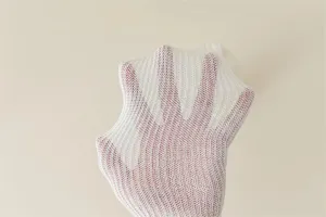 Detailed view of white mesh knit socks showing stretchy vertical striped fabric and elasticity.