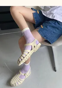 Close-up detail of purple mesh hollow mid-tube socks, breathable summer style design.