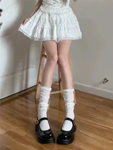 Detailed close-up shot of white bubble cuff slouch socks paired with classic black Mary Jane shoes.