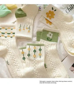 Japanese style cute floral embroidered mid-tube socks, soft knit white socks with green trim.