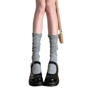Grey slouch socks paired with black Mary Jane shoes, stylish daily wear for women.