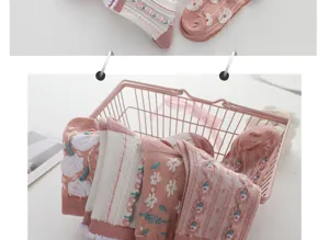 Cute pink mid-calf socks for women featuring sweet floral embroidery and vintage knitted stripes.