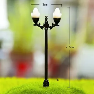 Miniature plastic double head street lamp for moss micro landscape DIY garden decor detail.