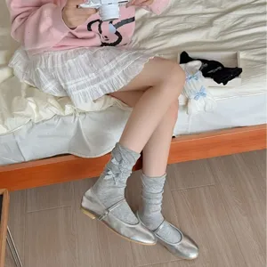 Cute grey mid-tube socks for women with sweet blue bow decorations, soft daily wear style.